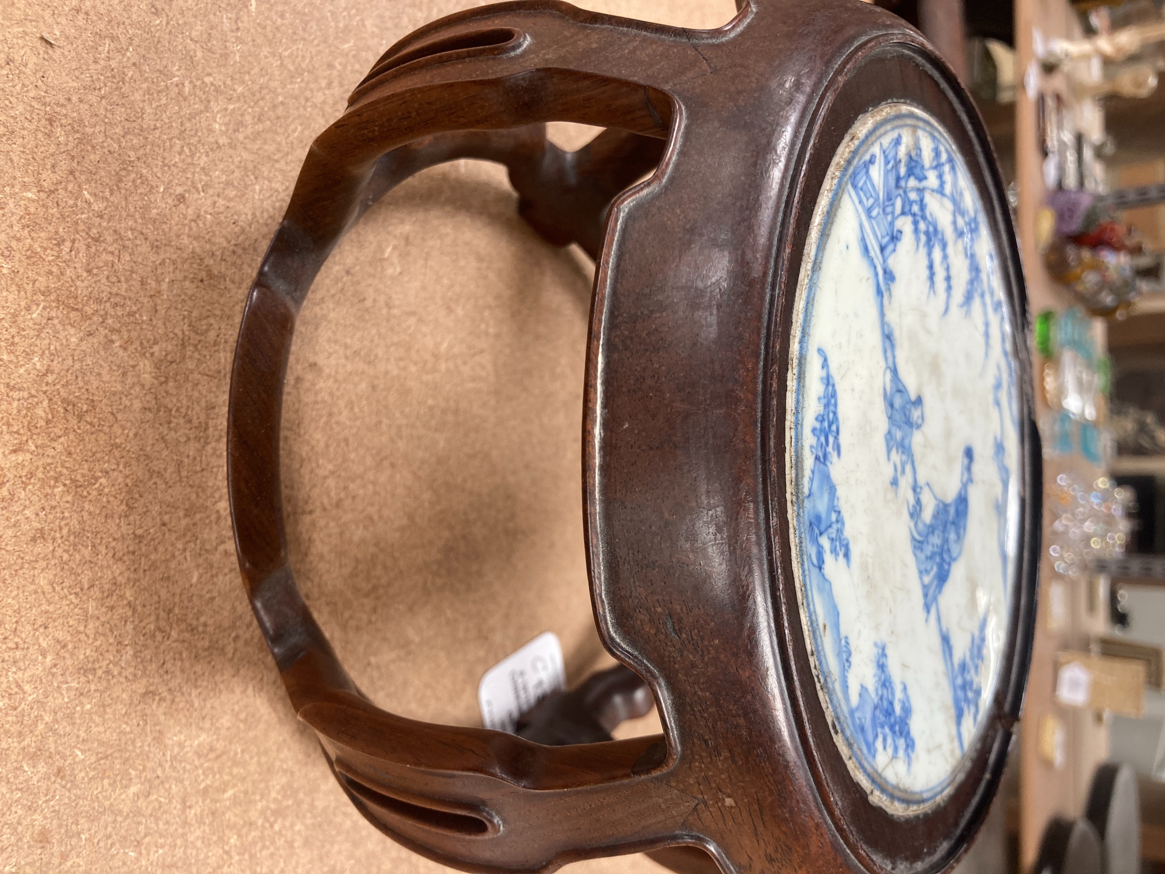 A 19th century Chinese blue and white circular tile inset hongmu stand, 22cm